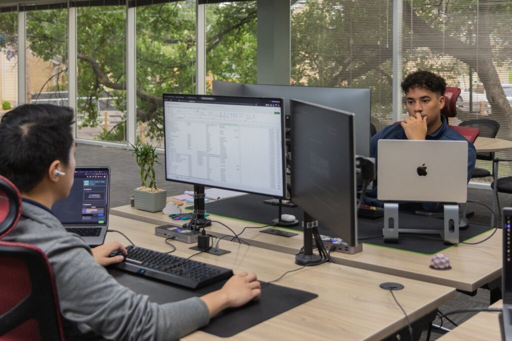 Contigo Technology team members working at computer workstations